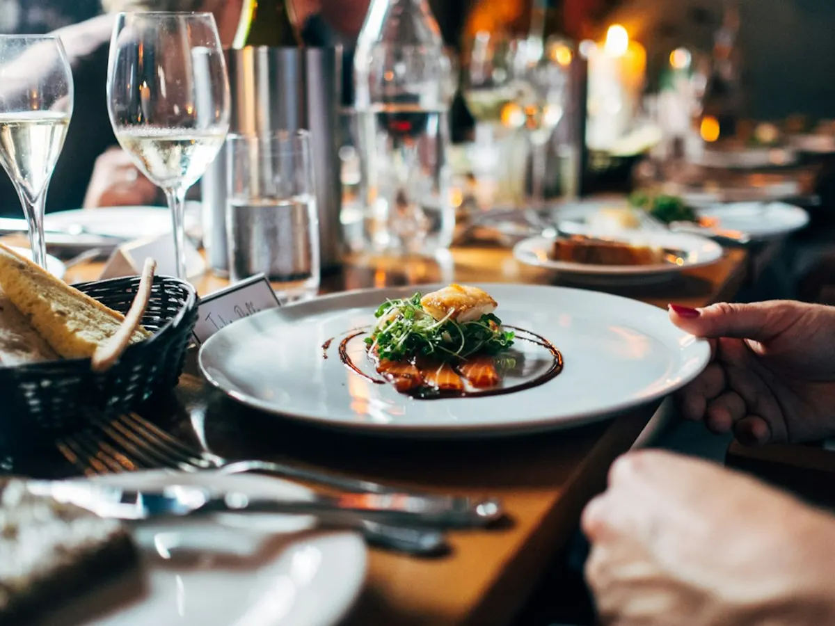 A carefully plated meal being served at a contemporary restaurant table